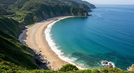 Coastal landscape with turquoise water sandy beach and green hills on sunny day