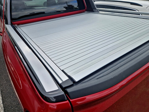 Cover with tail gate locking system designed to fit all standard vehicle security accessory offering quick and easy way to safely lock away your load. fuel saving, proitection thief, lock, red, silver