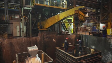 Metallurgy workers pouring molten metal in foundry. Stock clip