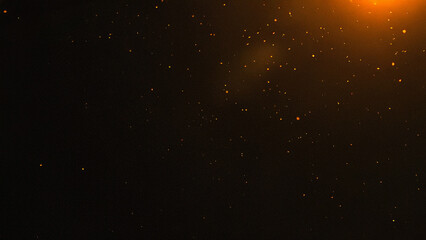 Dark abstract background with glowing orange particles and warm light flare, cinematic effect overlay. Ideal for dramatic video overlays, photography, and digital design projects.