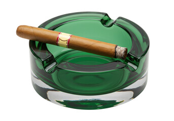 Isolated glass ashtray containing a lit cigar, resting in the depression on the rim edge © Johanna