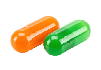 Isolated colorful pills close up medical concept green and orange capsule medicine drugs