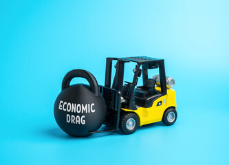 The economic drag slows down the development of business and industry. Symbol of stagnation, slowdown, and lack of investment. Macroeconomics, industrial policy, and business growth barriers.