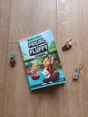 Naklejka premium Minecraft Friciel et Fluffy Book with Minecraft Toys on Wooden Background - Editorial