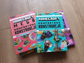 Naklejka premium Minecraft construction book covers featuring characters and structures on a wooden surface