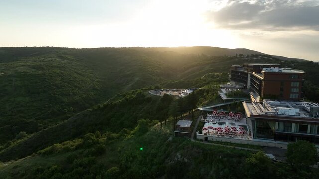 Sighnaghi, Georgia - July 15 2025: Aerial view of modern hilltop hotel Bodbe. Complex with Pool Terrace Overlooking Lush Green Valleys and Distant Horizon over Sighnaghi city