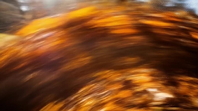 Abstract amber waves and dark hues blend in dynamic motion, creating texture