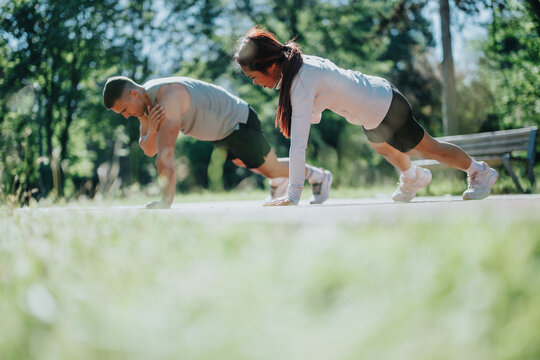 People engaging in a fitness activity outdoors, emphasizing partnership, cooperation, and healthy lifestyles in a natural environment, embodying motivation and commitment to fitness and wellbeing.
