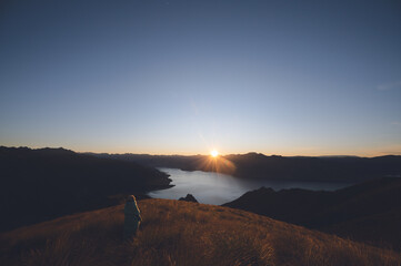 Hiker Watching Sunrise from Isthmus Peak, Wanaka, New Zealand