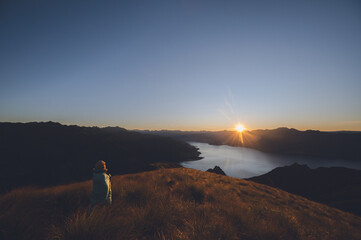 Hiker Watching Sunrise from Isthmus Peak, Wanaka, New Zealand
