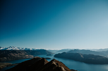 Hiker Standing on Roys Peak Viewpoint Overlooking Lake Wanaka and Southern Alps, New Zealand