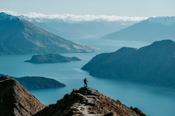 Hiker Standing on Roys Peak Viewpoint Overlooking Lake Wanaka and Southern Alps, New Zealand