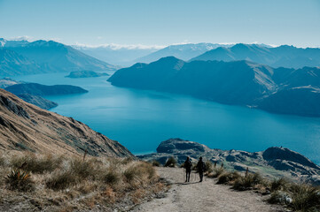 Hiker Walking on Roys Peak Track Overlooking Lake Wanaka, New Zealand