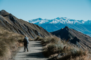 Hiker Walking on Roys Peak Track Overlooking Lake Wanaka, New Zealand