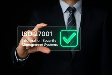 ISO 27001 information security management systems certification standard concept with a business person holding a digital holographic screen showing an approved checkmark and text