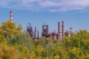 Abandoned industrial complex surrounded by vibrant greenery