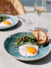 Sunny-side up eggs with toast salad on blue plate