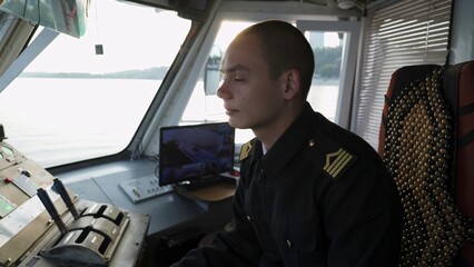 Ship captain steering a ferry or river boat. Clip