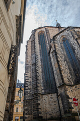 Massive medieval brick walls of the Gothic Church of Our Lady before Týn rising above a narrow back lane in Prague Old Town, Czech Republic