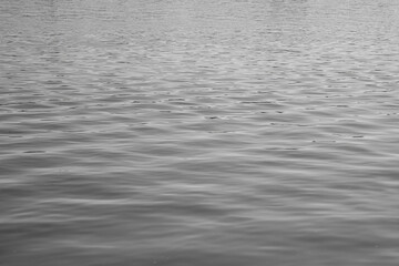 Capturing the serene texture of a calm river surface at sunset