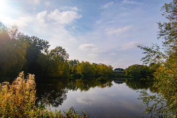Fototapeta premium The river Trent with trees in autumn color and reflection on the water.