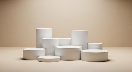 A collection of white cylindrical and circular pedestals of varying heights arranged in a cluster on a neutral beige background, suitable for product display