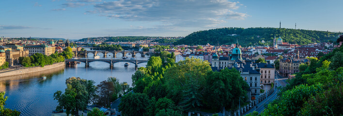 Panoramic view of Prague and the Vltava River in a lovely May evening with clear sky, Czech Republic, capturing a fresh spring atmosphere