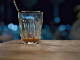 Hot Thai tea and roti drinks at a night shop with lights and bokeh.
