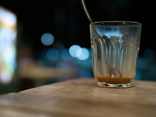 Hot Thai tea and roti drinks at a night shop with lights and bokeh.