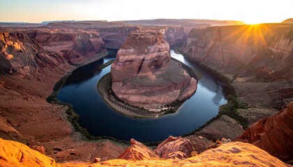 Aerial landscape of a U-shaped canyon bend with a sunset