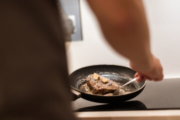 the process of cooking beef steak in a frying pan