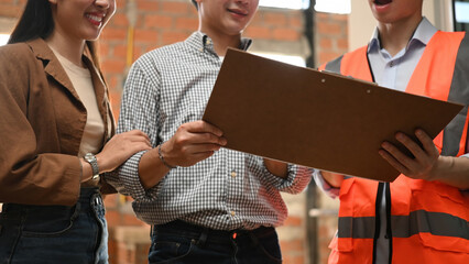 Home renovation concept Cropped shot of discussion between a contractor and a couple, discussing...