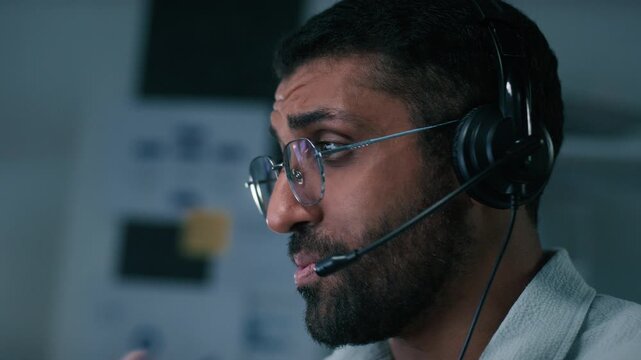 Male Call Center Customer Service Agent with Headset at Office Computer, Professional Operator Providing Helpline Support, CRM Consultation, Telemarketing and Remote Online Communication with Clients.