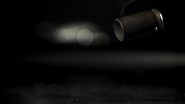 Cartridges from a pistol shot fall to the floor. Filmed on a high-speed camera at 1000 fps. High quality FullHD footage