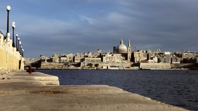 The skyline of Valletta, Malta, a fortified city, seen from across the Grand Harbour. The UNESCO World Heritage Site features the dome of St. Paul's Pro-Cathedral and historic bastions.