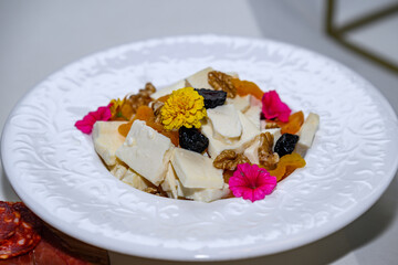 A plate of cheese with walnuts and figs 