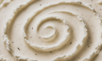 Vanilla Bean Ice Cream Macro Texture with Scoop Ridges in Circular Swirl, Photorealistic Food Background