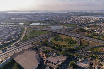 An aerial view infrastructure  of Surabaya is visible, namely the Dupak toll road or highway area 