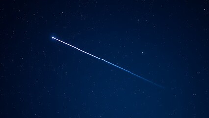 A brilliant meteor streak with a glowing tail in a star-filled night sky.