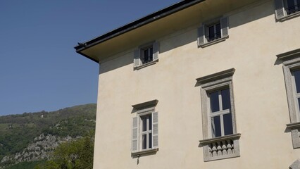 Elegant building facade with stone details and shutters. Action