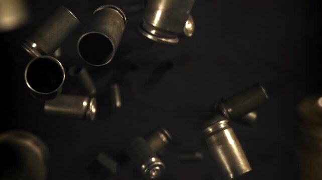 Bullet casings fly up and fall. Filmed on a high-speed camera at 1000 fps. High quality FullHD footage