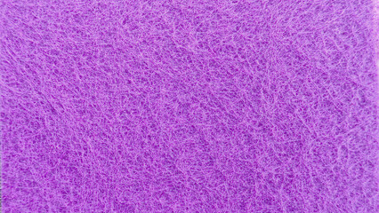 Vibrant Macro Purple Non-Woven Synthetic Scourer Pad Texture Background with Tangled Fibers, Ideal for Cleaning, Abstract, or Craft Concepts.