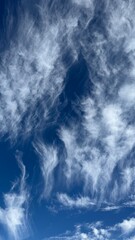 Wispy White Clouds on a Blue Sky Background