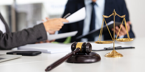 Lawyer and an attorney discuss the contract. A successful businessman reviews the agreement. Concept of business deal and legal consultation.