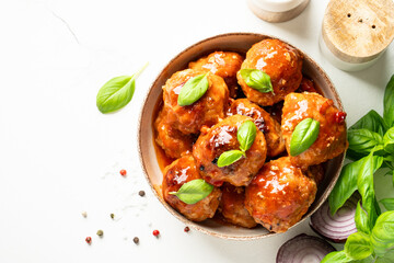 Meatballs in tomato sauce on white background.