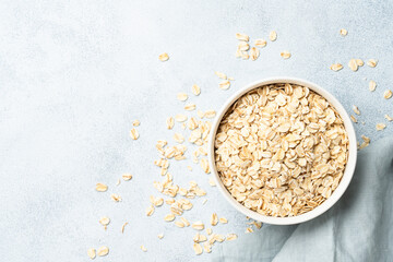 Rolled oats flakes in a wooden bowl with ears.