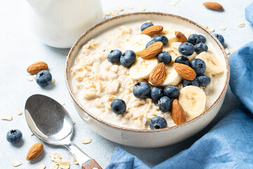 Oatmeal porridge with bananas, nuts and blueberries.