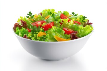 Fresh vibrant mixed green salad with tomatoes and peppers in a white bowl