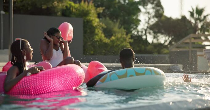 Bonding, relax and splash with friends in swimming pool together for holiday or vacation. Party, summer and water with group of happy people outdoor at hotel, lodge or resort for weekend getaway