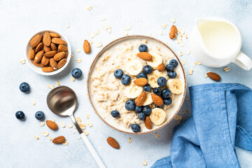 Oatmeal porridge with milk, bananas and blueberries.